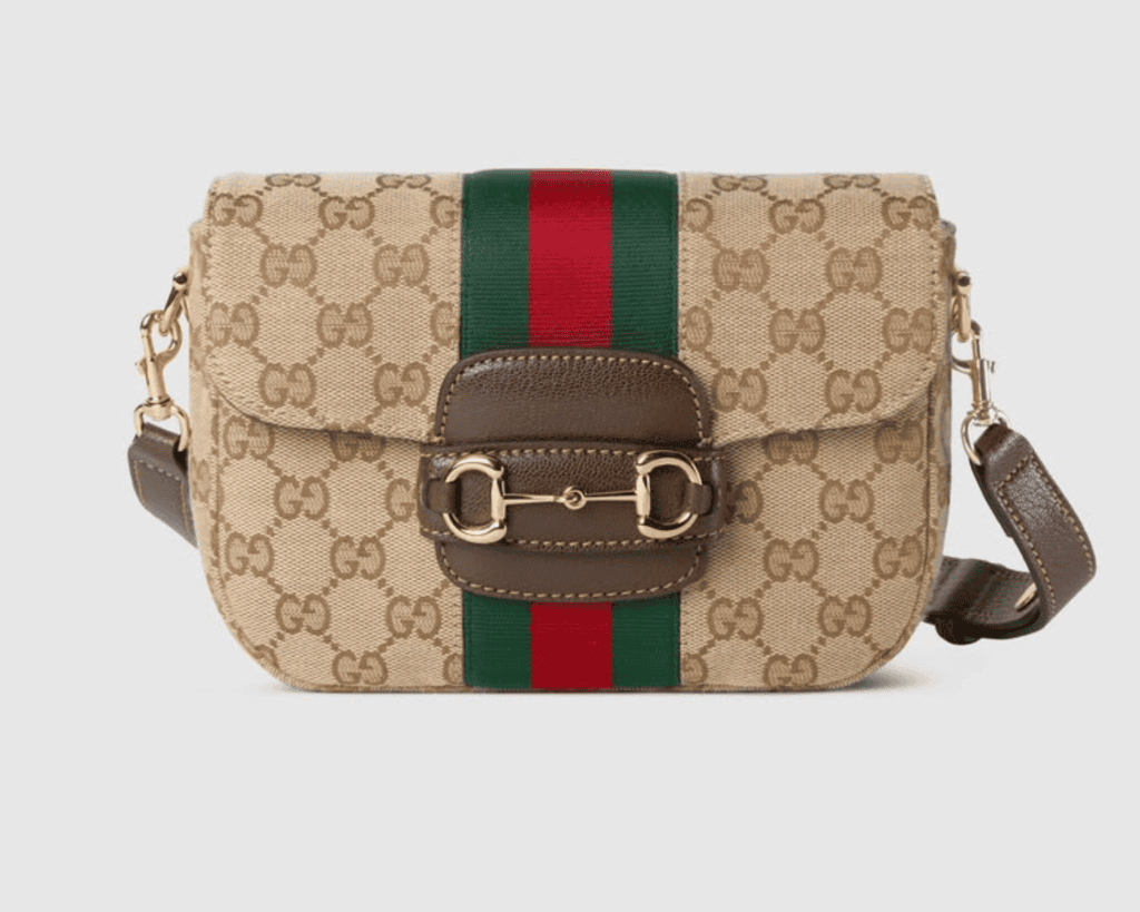 Gucci Horsebit 1955 small shoulder bag in sand and brown original GG canvas featuring a vertical green and red Web stripe, a brown leather flap tab, and a gold-tone horsebit closure.