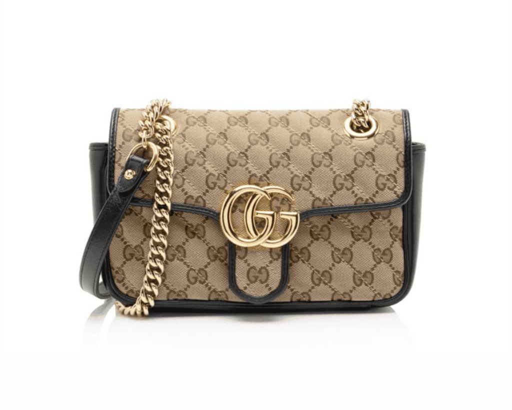 Gucci GG Marmont small shoulder bag in beige and ebony diagonal quilted GG canvas featuring smooth black leather trimmings, a sliding gold-tone chain strap, and the signature Double G logo hardware.