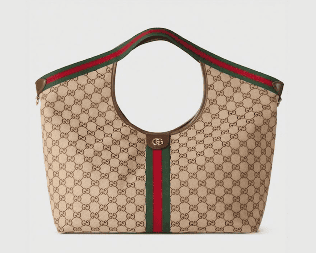 Gucci Giglio large tote bag in beige and brown GG Supreme canvas featuring an open curved silhouette, a vertical green and red Web stripe, and matching integrated shoulder handles.