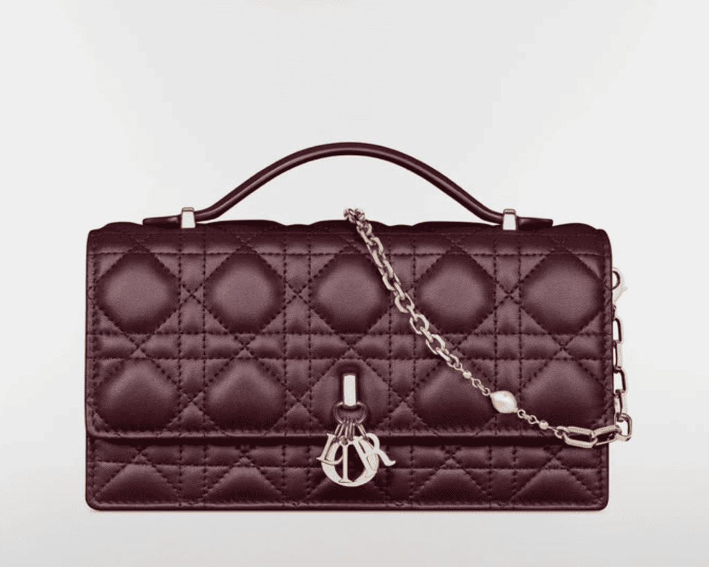 My Dior top handle bag in deep amaranth burgundy lambskin leather with geometric Cannage quilting, a structured single handle, and a gold-tone D.I.O.R. charm drop clasp.