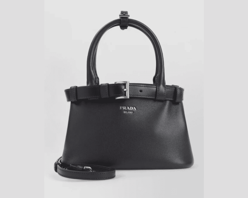 Prada Buckle small handbag in smooth black leather featuring dual top handles wrapped by an integrated leather belt with a silver-tone buckle and PRADA MILANO lettering logo.